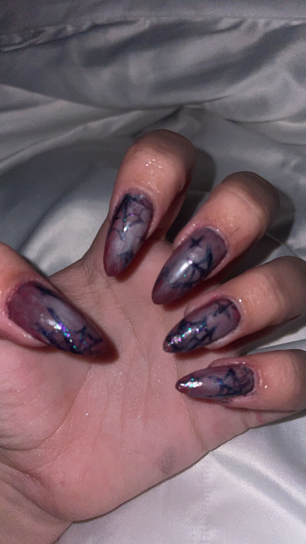 Purple nail with spider webs paint on them